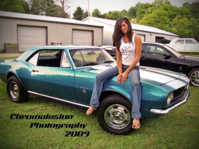 Natalie sitting on Camaro
