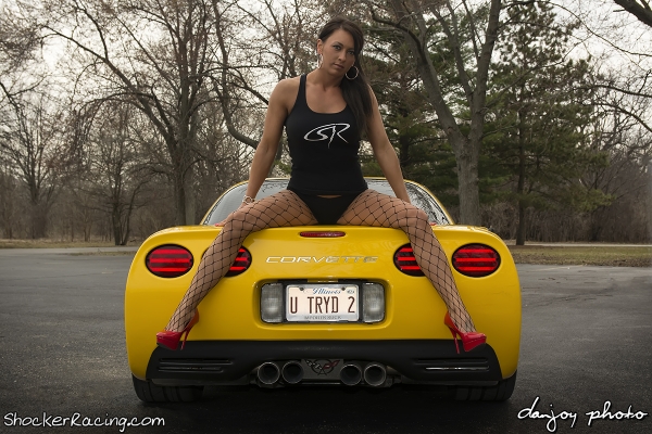 Jamie Barwick sitting on trunk of Corvette Z06