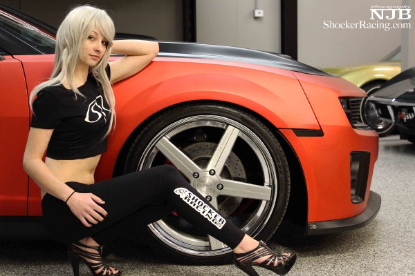 Brenda Lezon wearing the ShockerRacing Leggings with a Camaro